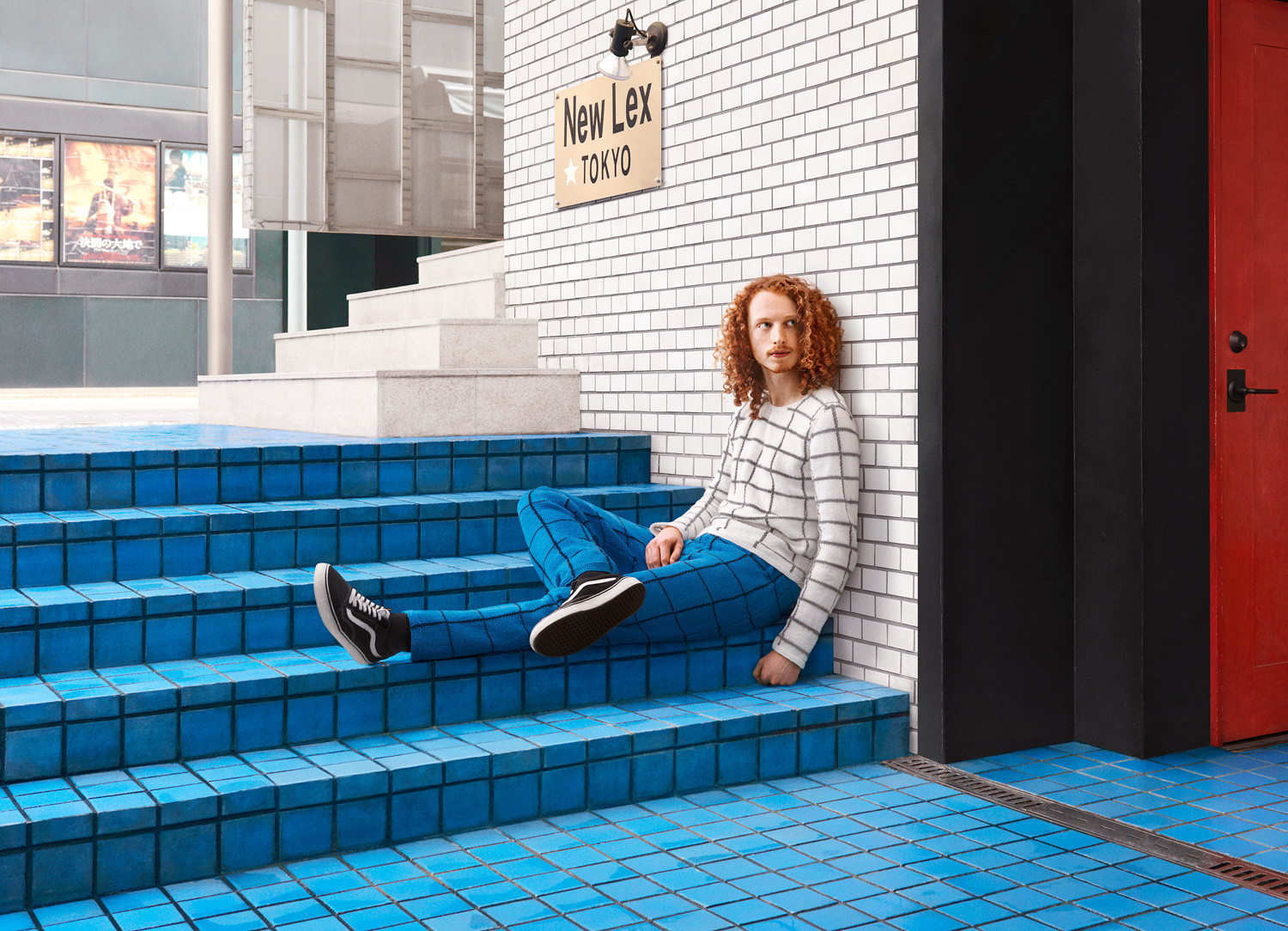 A man with a matching jumper on stairs